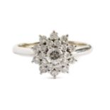 An 18 ct. white gold and brilliant cut diamonds cluster ring