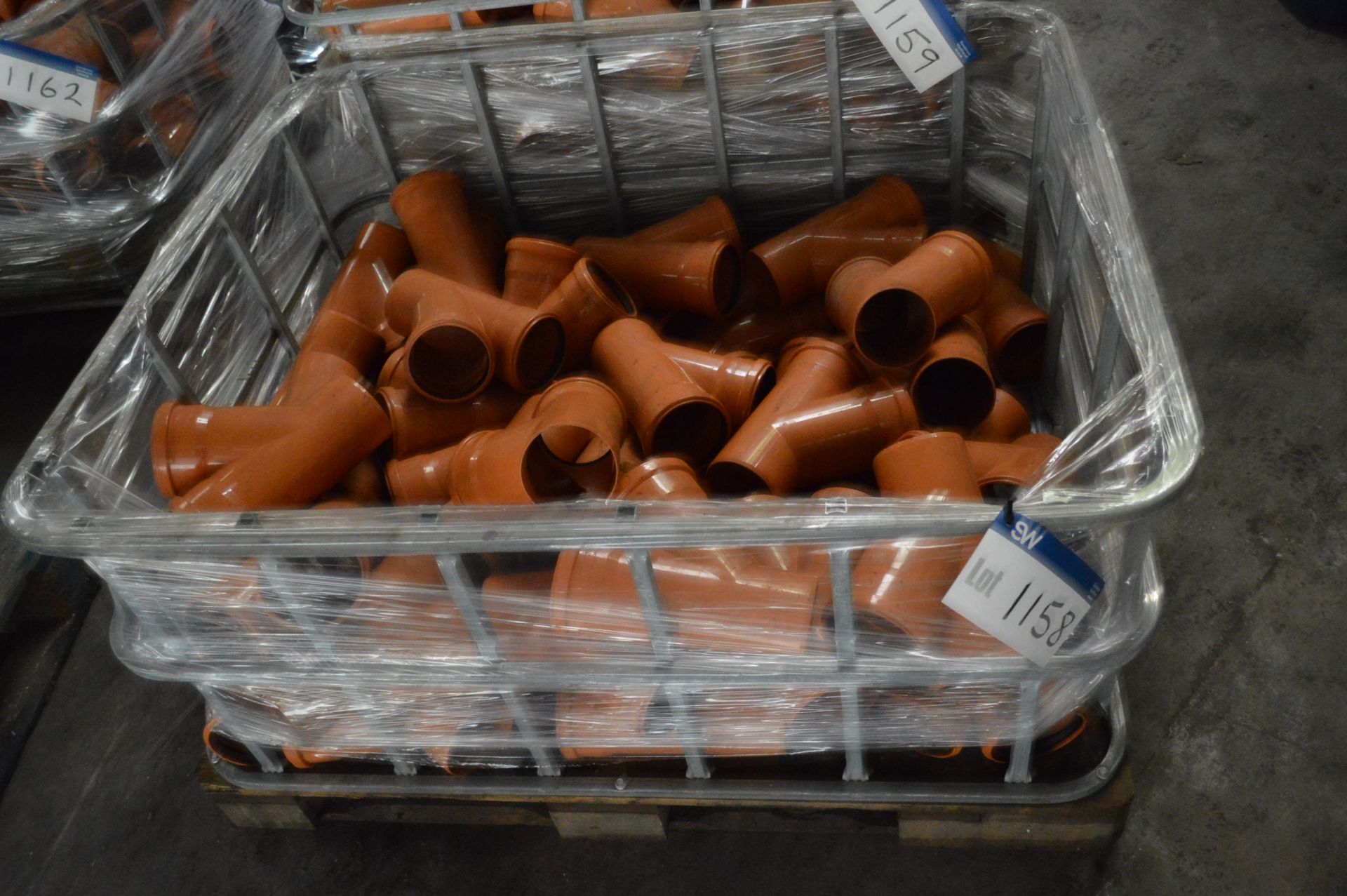 Assorted Plastic Pipe Fittings, in steel cage (container(s) not included)