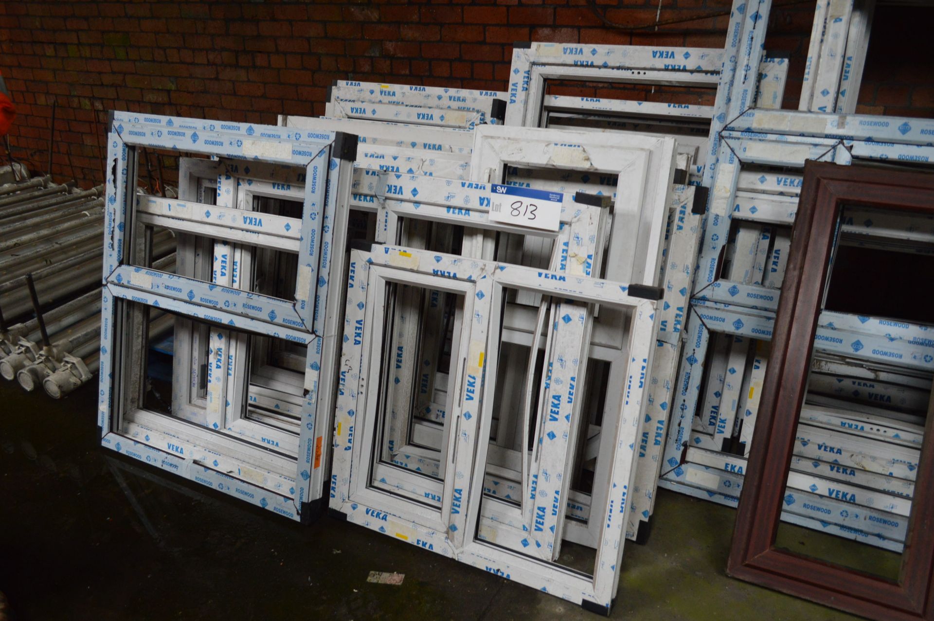 Assorted Plastic Window Frames, leant against wall in one line...