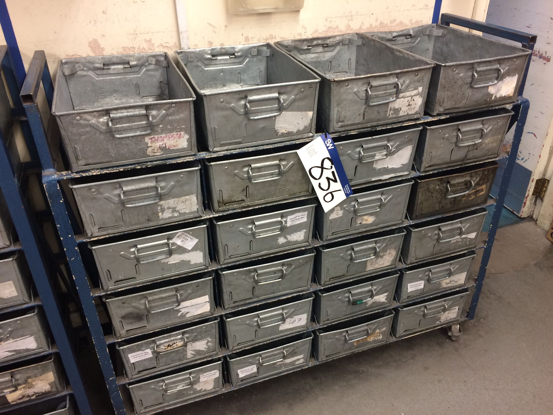 24 Tote pans in mobile steel rack