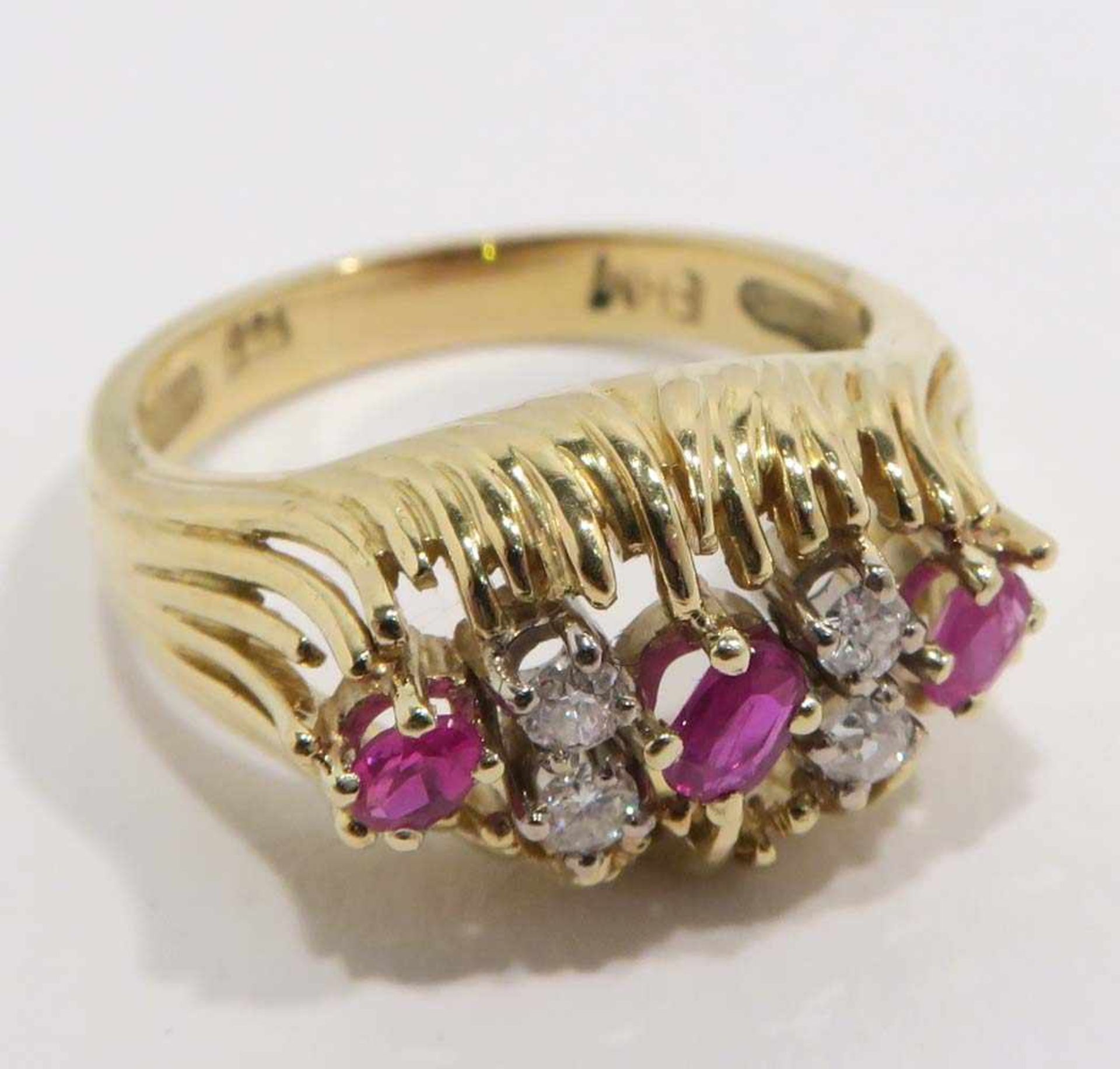 Ring18 K GG, Marken (750, "EHM"). Mit drei Rubinen und vier Kleindiamanten besetzt. Ringgröße 61.