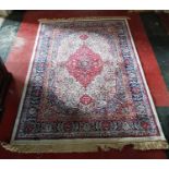 An Ivory ground Kashmir Rug with a traditional medallion design