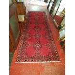 A Red ground handwoven Persian Runner