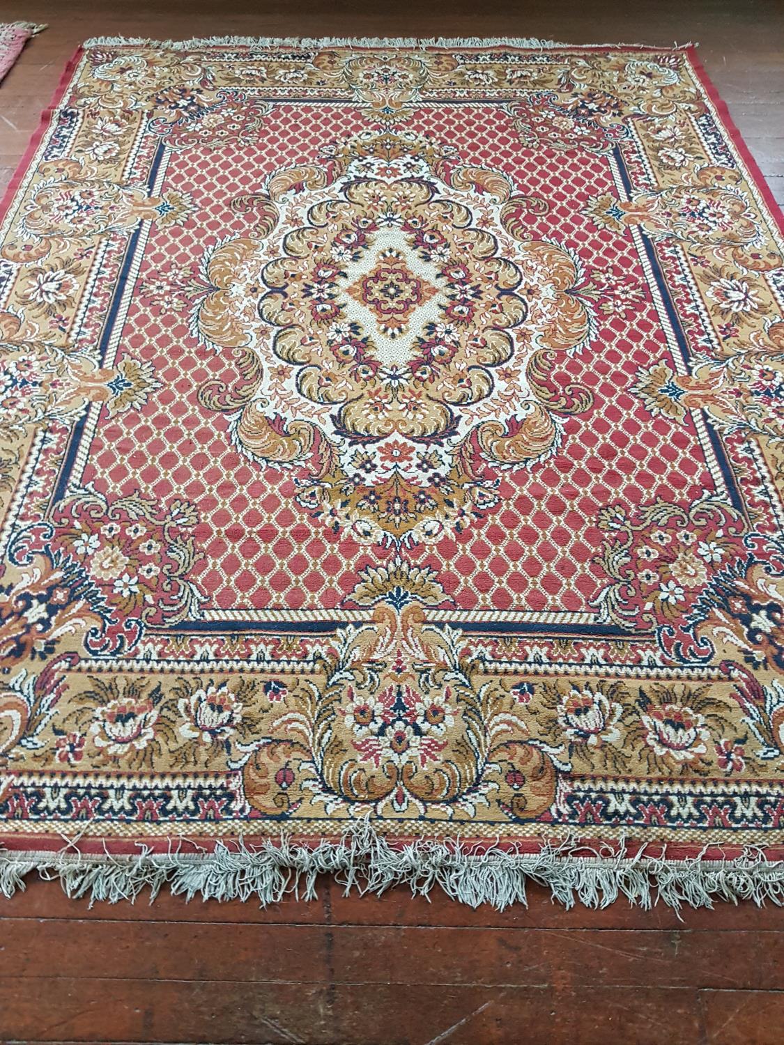 A multi bordered Rust ground Rug with allover decoration. 304cm x 240cm.