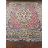 A multi bordered Rust ground Rug with allover decoration. 304cm x 240cm.