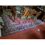 A large Red ground Persian cashcon Carpet with a multi coloured medallion design