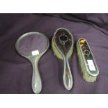 A 1920's three piece matched HM silver dressing table set having tortoise shell backs with pique