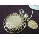 A yellow metal St Christopher pendant stamped 375 and a yellow metal St George pendant in a