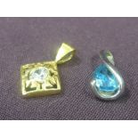 A 9ct white gold pendant having tear drop blue topaz and a yellow metal pendant previously tested as