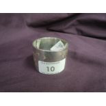 An HM silver napkin ring of plain form bearing monogram