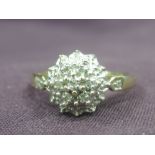 A lady's dress ring having a diamond chip cluster in an illusionary mount on a 9ct gold loop, size