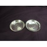 A pair of silver trinket dishes of plain circular form having George V Silver jubilee coin