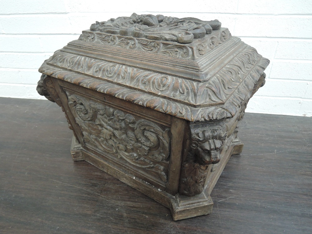 A Victorian oak wine cellaret/cooler of large sarcophagus form having extensive foliate carved