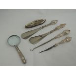 Five HM silver handled dressing & manicure tools including shoe horn, nail buffer, and an HM