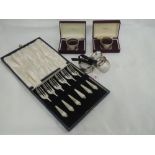 Five HM silver napkin rings of various designs including two cased, and a cased set of six silver