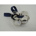 Four HM silver napkin rings including pair of half moon form having engine turned decoration and