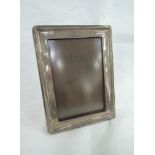 A silver photograph frame of plain rectangular form having wooden back, Birmingham 1915, A & J