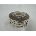 An Edwardian silver and tortoise shell trinket box of circular form having silver picque