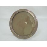 A silver photograph frame of plain circular form having wooden back, Birmingham 1915, A & J