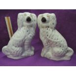 A pair of Edwardian Staffordshire mantel dogs of traditional design