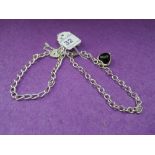 A silver charm bracelet having padlock clasp and another similar having heart shaped charm