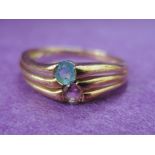 A lady's dress ring having a pink and pale blue stoneon triple twist mount on a 9ct gold loop,