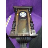 An early 20th century mahogany cased vienna style wall clock having half pillar decoration with