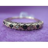 A lady's half eternity ring having sapphire and diamond chip decoration on a 9ct gold loop, size R