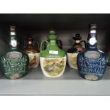 Six empty ceramic Whisky decanters