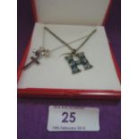 Two white metal pendants including enamelled H and cross