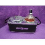 A vintage musical bar set with glass decanter and ice bucket