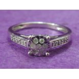 A lady's dress ring having a diamond chip cluster within an illusionary square setting to diamond