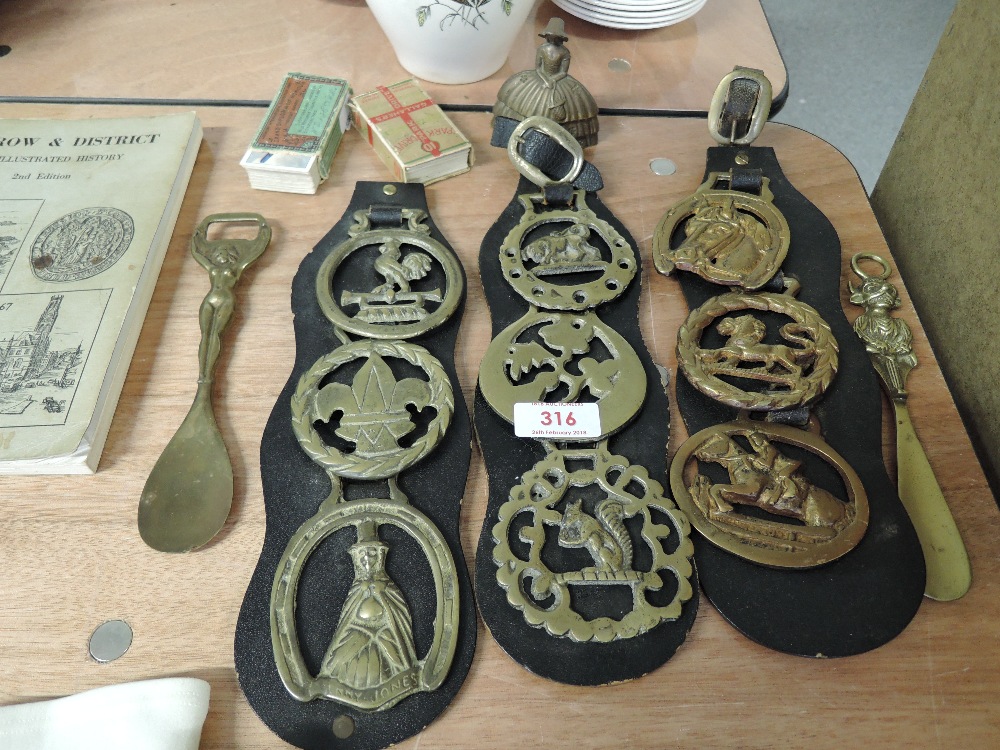 A selection of vintage horse brasses and unusual brass tasting spoon