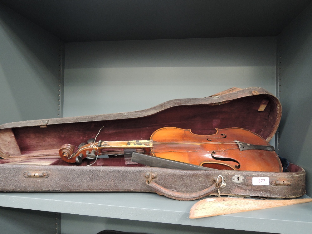 Two traditional violins, in some disrepair , with additional spares and one hard case, one