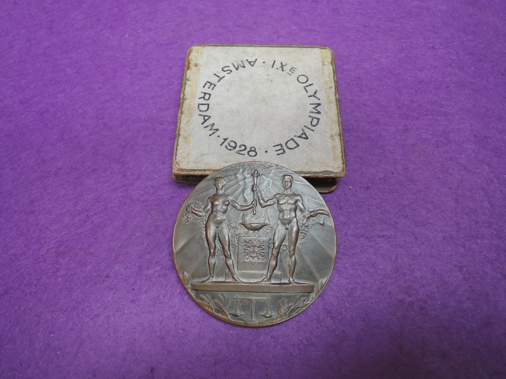 A 1928 Amsterdam Olympic games participation medal, in bronze designed by J C Wienecke, with