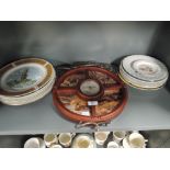 A selection of vintage ceramic display plates and wall mounted clock