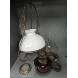 A selection of vintage and antique oil burning lamps including cranberry glass well