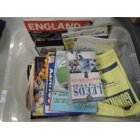 Two boxes of 1980's and later football matchday programmes and a selection of video's