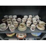 A selection of vintage royal coronation ceramics including Clarice Cliff tea cup and saucer set