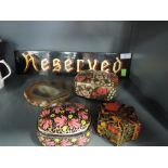 A selection of hand decorated papier mache trinket boxes and reserved sign