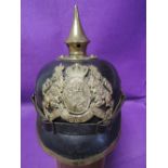 A German World War 1 black leather and brass Pickelhaube helmet with original leather fittings