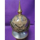 A German World War 1 metal and brass Pickelhaube helmet with neck guard, original leather