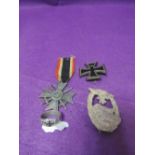 A collection of German military 1914 Iron Cross, 1939 Iron Cross, Luftwaffe Panzer badge and a white