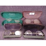 Four vintage yellow metal frame spectacles of traditional wire form including pince nez