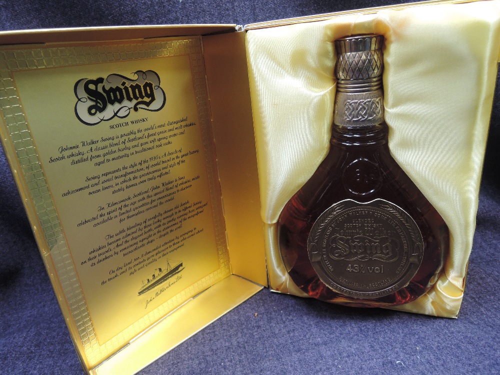 A bottle of Johnnie Walker Swing Whisky in gold colour box