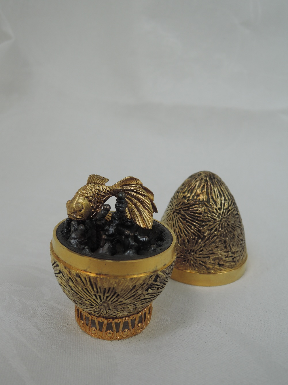 A cased Stuart Devlin 1971 silver gilt limited edition surprise Easter egg having a textured star