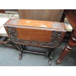 An early 20th century mahogany drop leaf occasional table having foliate carved decoration and