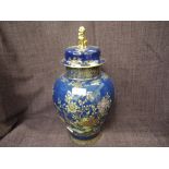 A Carltonware lidded jar having pictorial gilt heightened bleu royale decoration with Dog of Foe