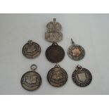 Five HM silver medallions including 1934 Westmorland Gazette baby show, athletics, an ARP cap