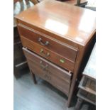 An Edwardian mahogany music cabinet having five fall front drawers on square frame